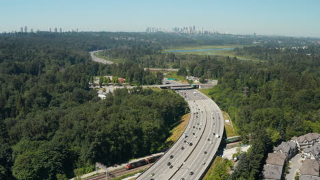 Aerial-drone-view-over-the-Trans-Canada-Highway-in-Burnaby-with-the-Vancouver-skyline-in-the-distance