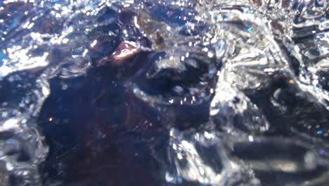 Clear-mountain-stream-waterfall-water-shot-from-underwater-then-revealing-a-small-waterfall