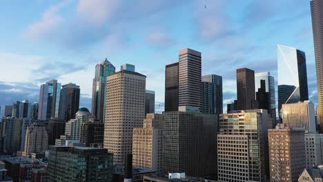 Rising-aerial-of-Seattle's-downtown-skyscrapers-with-light-fluffy-clouds-in-the-background