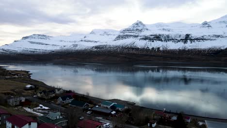 Pan-right-showing-village-next-to-one-of-east-Iceland's-fjords