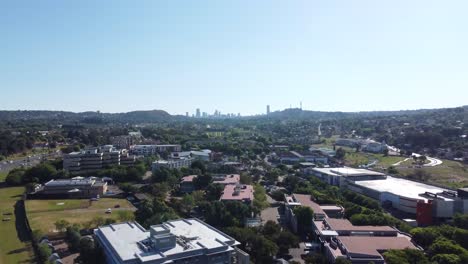 Bedfordview,-Johannesburg---Beautiful-drone-establishing-rise-plus-zoom-shot-of-the-city-of-Johannesburg-on-a-bright-sunny-day-in-Gauteng,-South-Africa