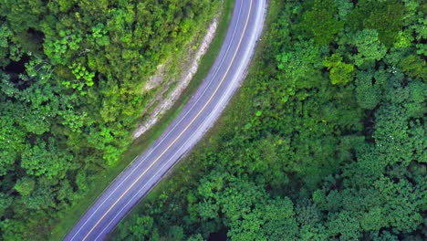 Aerial-top-down-shot-car-driving-on-rural-Carretera-Samana-Toll-Road-during-sunny-day
