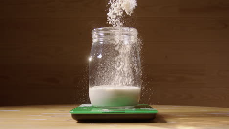 240fps-SLOW-MOTION,-flour-is-added-to-the-sourdough-starter-on-scales
