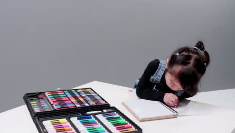 Child-choosing-black-pen-in-the-full-case-for-drawing