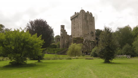 Tourist-In-Blarney-Castle-With-Greenery-Landscape-In-Blarney-Near-Cork,-Ireland
