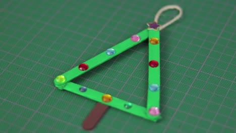 Christmas-tree-made-with-popsicle-sticks-on-a-cutting-mat
