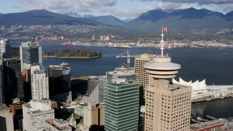 Vancouver-Lookout-at-Harbour-Centre-With-Canada-Place-In-Background-In-Canada---aerial-drone-shot