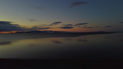 Slow-flying-drone-over-lake-Antelope-Island-State-Park-in-Northern-Utah-at-dusk