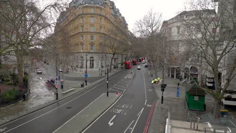 Static-shot-of-mounted-police-slowly-crossing-the-famous-and-empty-Northumberland-Ave,-London