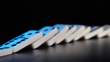 White-domino-dice-fall-on-a-black-background