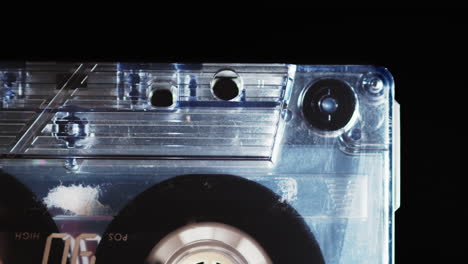 Closeup-of-tape-playing-inside-cassette,-isolated