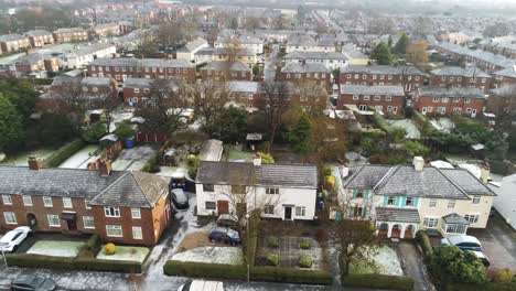 Aerial-view-frosty-white-winter-residential-town-neighbourhood-housing-estate-rooftops