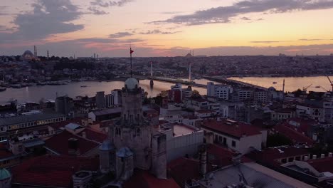 Aerial-is-flying-sideways-showing-Galata-Tower-in-Istanbul-after-sunset,-Turkey