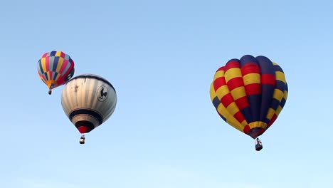 Low-angle-view-of-three-balloons-flying-at-Bristol-balloon-fiesta