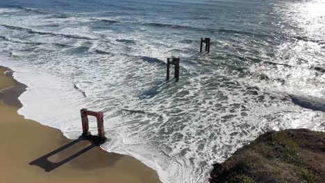 Pedestal-Shot-of-the-Broken-Down-Davenport-Pier-and-Pacific-Coast-on-Highway-One-in-Northern-California