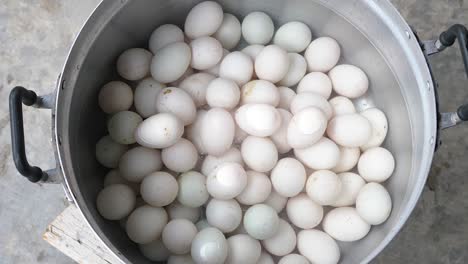 Top-down-motion,-boiled-duck-eggs-on-stainless-steel-pan-with-steam---Thailand-food