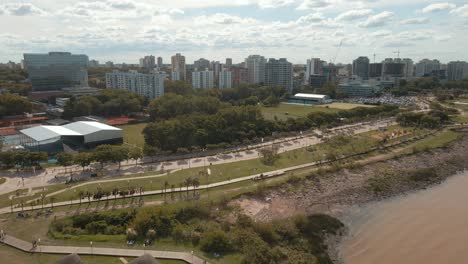 Aerial-view-of-Vicente-Lopez-coastal-walk-with-buildings-and-cloudy-sky-behind