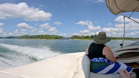 Woman-in-rear-of-cockpit-of-sports-boat-that-is-cruising-on-Table-Rock-Lake-on-a-cloudy-afternoon