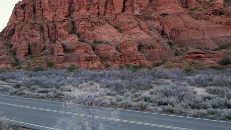 Endurance-road-bike-trip-across-Utah-desert,-extreme-activity,-aerial-view