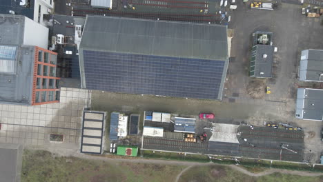Top-down-jib-up-of-solar-panels-on-the-side-of-industrial-rooftop