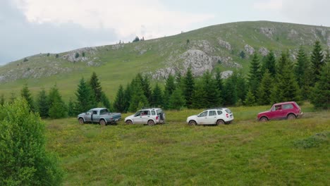 Cars-on-the-road-through-meadow-on-Jadovnik-mountain,-Serbia