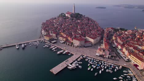 Harbor-with-boats-of-Rovinj-revealing-old-town-hill-with-Church-of-St