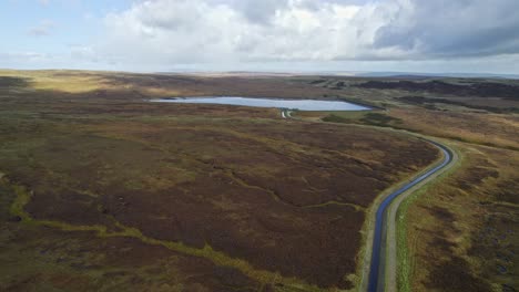 Drone-video-footage-of-a-reservoir-and-overflow-system-in-the-Saddleworth-moors-in-West-Yorkshire-UK,-Rising-aerial-footage