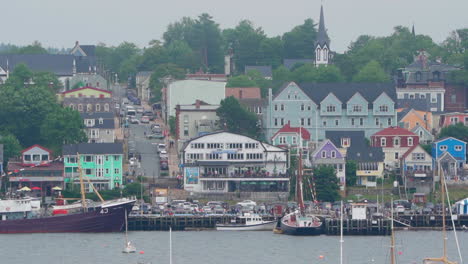Small-colourful-community-town-with-houses-and-businesses-in-Nova-Scotia,-Canada-on-an-overcast-day