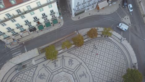 Slow-motion-aerial-top-down-of-the-Luís-de-Camões-square-with-car-traffic