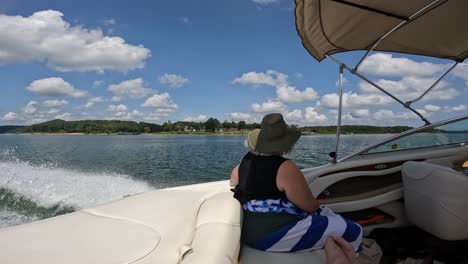 Slow-Motion-of-Woman-enjoying-the-scenery-from-the-cockpit-of-sports-boat-while-cruising-on-Table-Rock-Lake-on-a-sunny-afternoon