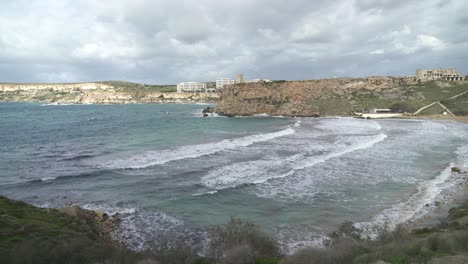 Panoramic-Shot-of-Ghajn-Tuffieha-Bay-with-Strong-Wind-Blowing-Over-Mediterranean-Sea