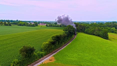 An-Aerial-Following-View-of-an-Antique-Steam-Passenger-Train-Blowing-Black-Smoke-Thru-Pennsylvania-Farm-Lands