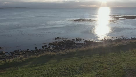Bright-sunset-at-calm-coast-bay-of-Iceland-peninsula,-aerial