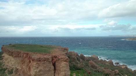 AERIAL:-Beautiful-Blue-Sky-with-Mediterranean-Sea-near-Il-Qarraba-Rock-in-Malta