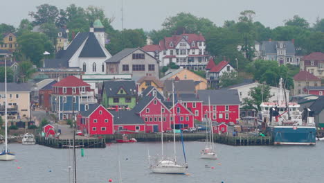 Small-colourful-community-with-homes-and-stores-in-Nova-Scotia,-Canada-on-an-overcast-day