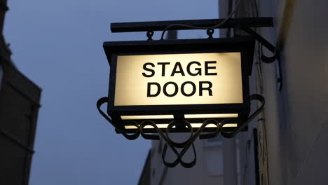 Illuminated-stage-door-sign-outside-a-theatre-in-London