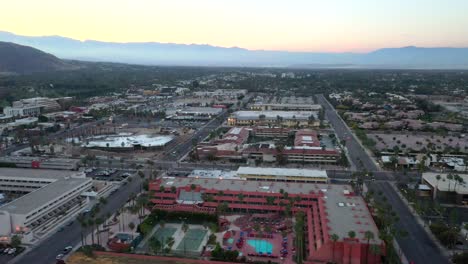 Drone-shot-flying-over-Palm-Springs-city-in-California-at-sunset
