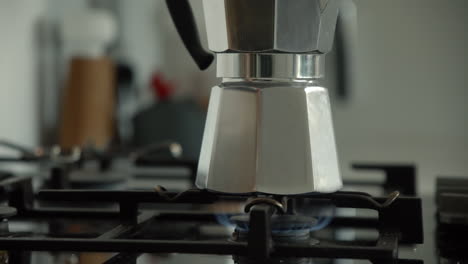 Traditional-Bialetti-Moka-Express-Coffee-Maker-brewing-coffee-on-a-gas-stove-in-the-morning