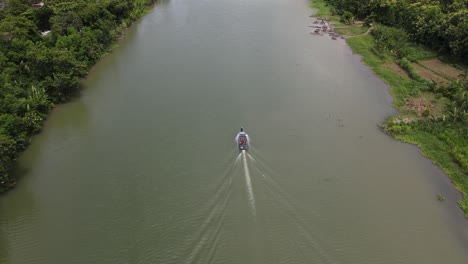 Aerial-view-of-a-traditional-boat-running-on-the-Opak-River,-Yogyakarta-with-a-beautiful-view