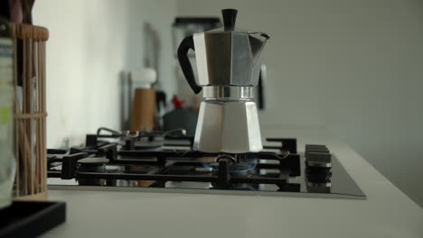Traditional-Bialetti-Moka-Express-Coffee-Maker-brewing-coffee-on-a-gas-stove-in-the-morning