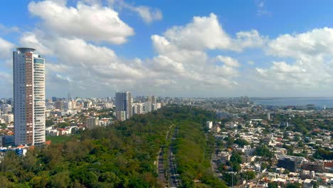 Drone-shot-of-the-Mirador-Sur-Park,-sunny-day-with-the-city-and-the-Caribbean-Sea-in-the-background
