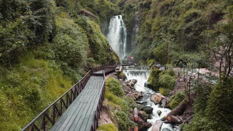 Aerial-View-Along-Empty-Wooden-Bridge-Leading-To-Peguche-Waterfalls-In-Otavalo