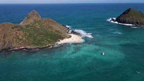 Wide-Orbit-Shot-Over-Beautiful-Turquoise-Sea-And-Mokulua-Island-Beach