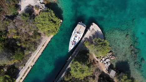 Birdseye-Drone-Aerial-View-of-Boat-in-Canal-on-Adriatic-Sea-Coastline,-Croatia