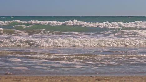 Empty-beach,-waves-crashing-at-the-shore-in-slow-motion