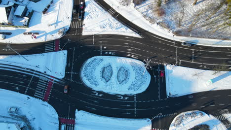 Aerial-view-on-a-complicated-multilane-circular-road-intersection-in-Gdansk,-Poland-on-a-winter-snowy-day