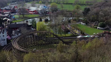 Gulliver's-world-Warrington-rollercoaster-theme-park-aerial-view-above-amusement-ride-testing-on-tracks-slow-right