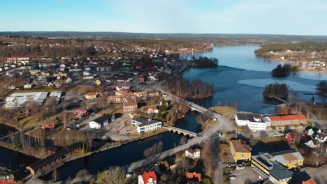 Ascending-aerial-shot-of-rural-swedish-village-during-sunny-day-in-autumn