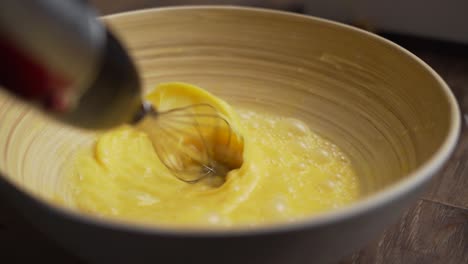 Whisking-eggs-with-a-hand-blender-in-slow-motion
