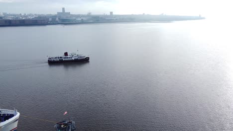 Aerial-view-following-Mersey-commuter-passenger-ferry-cruise-in-shimmering-river-to-Woodside-terminal-Birkenhead